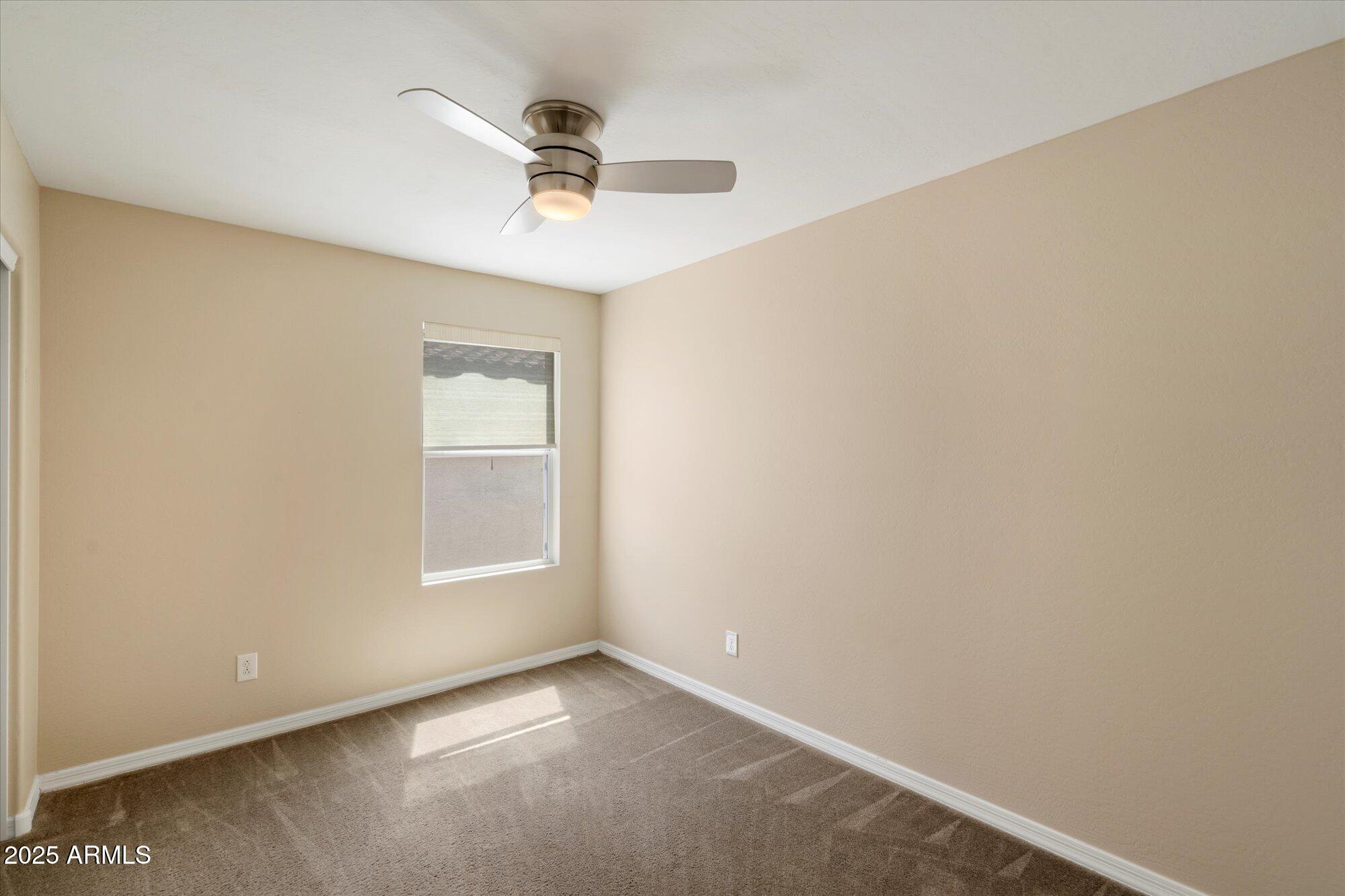 737 East Harwell Road Phoenix, AZ 85042 - Photo 23 of 28 an empty room with a window and a ceiling fan