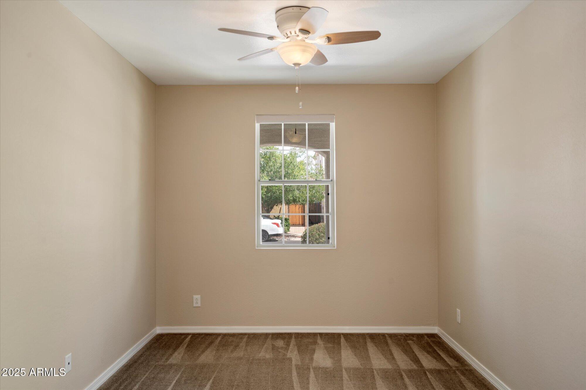 737 East Harwell Road Phoenix, AZ 85042 - Photo 24 of 28 an empty room with windows and ceiling fan
