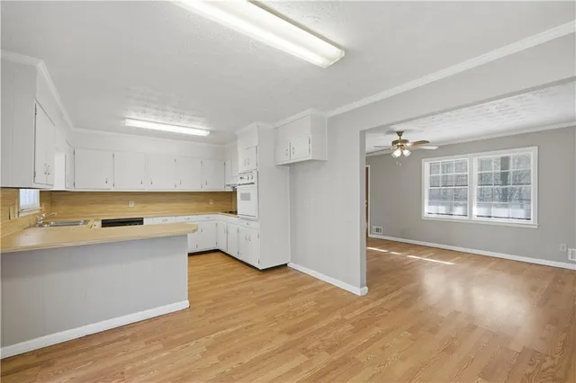 a view of kitchen with wooden floor and electronic appliances