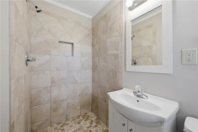 a bathroom with a sink a toilet and shower