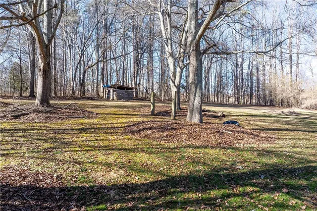 a view of a house with a yard covered with snow