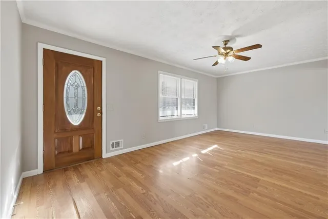 wooden floor in an empty room with a window