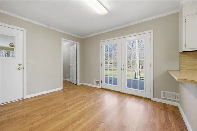 a view of an empty room with glass door