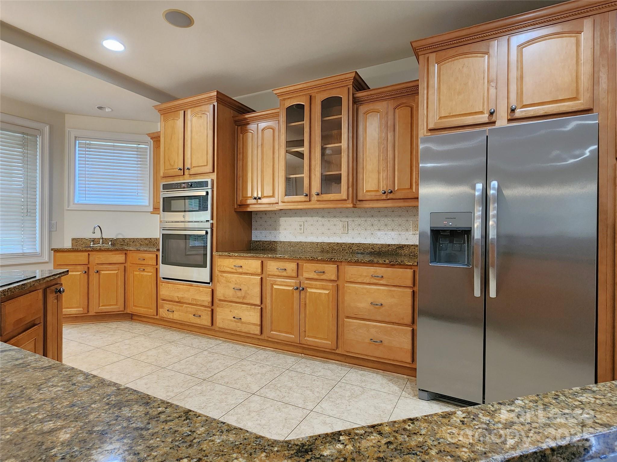 5524 Strabane Drive Matthews, NC 28104 - Photo 11 of 41 a kitchen with stainless steel appliances granite countertop a refrigerator and a stove top oven