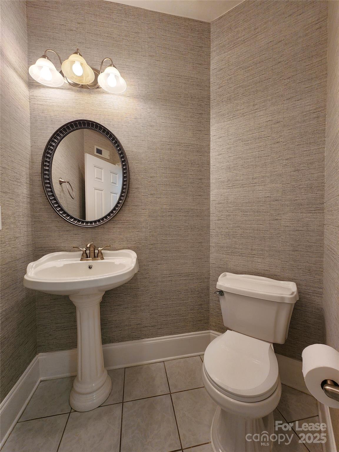5524 Strabane Drive Matthews, NC 28104 - Photo 16 of 41 a bathroom with a toilet a sink and a mirror