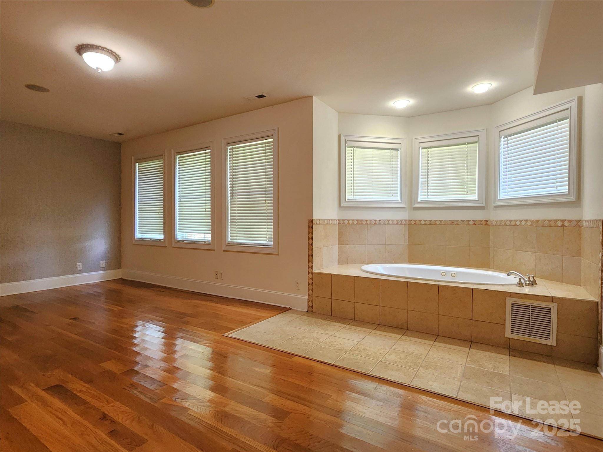 5524 Strabane Drive Matthews, NC 28104 - Photo 18 of 41 a view of an empty room with wooden floor and a window
