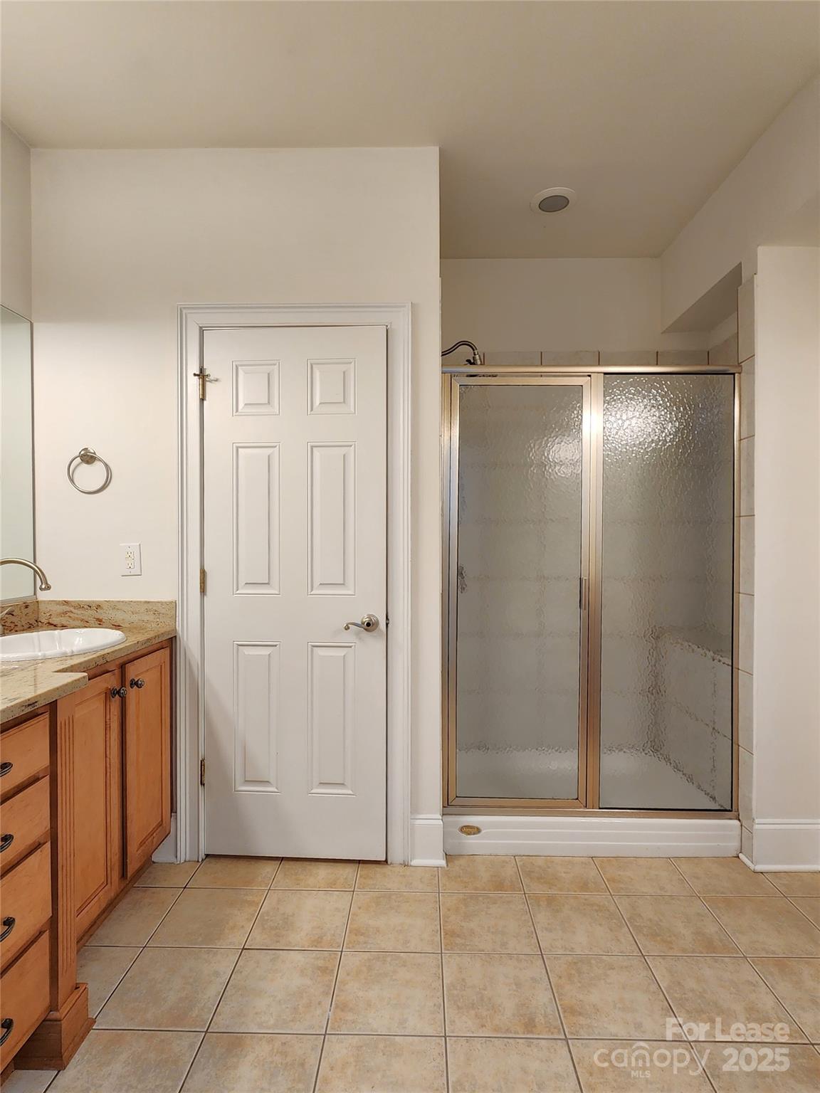 5524 Strabane Drive Matthews, NC 28104 - Photo 21 of 41 a bathroom with a granite countertop sink a mirror and a shower