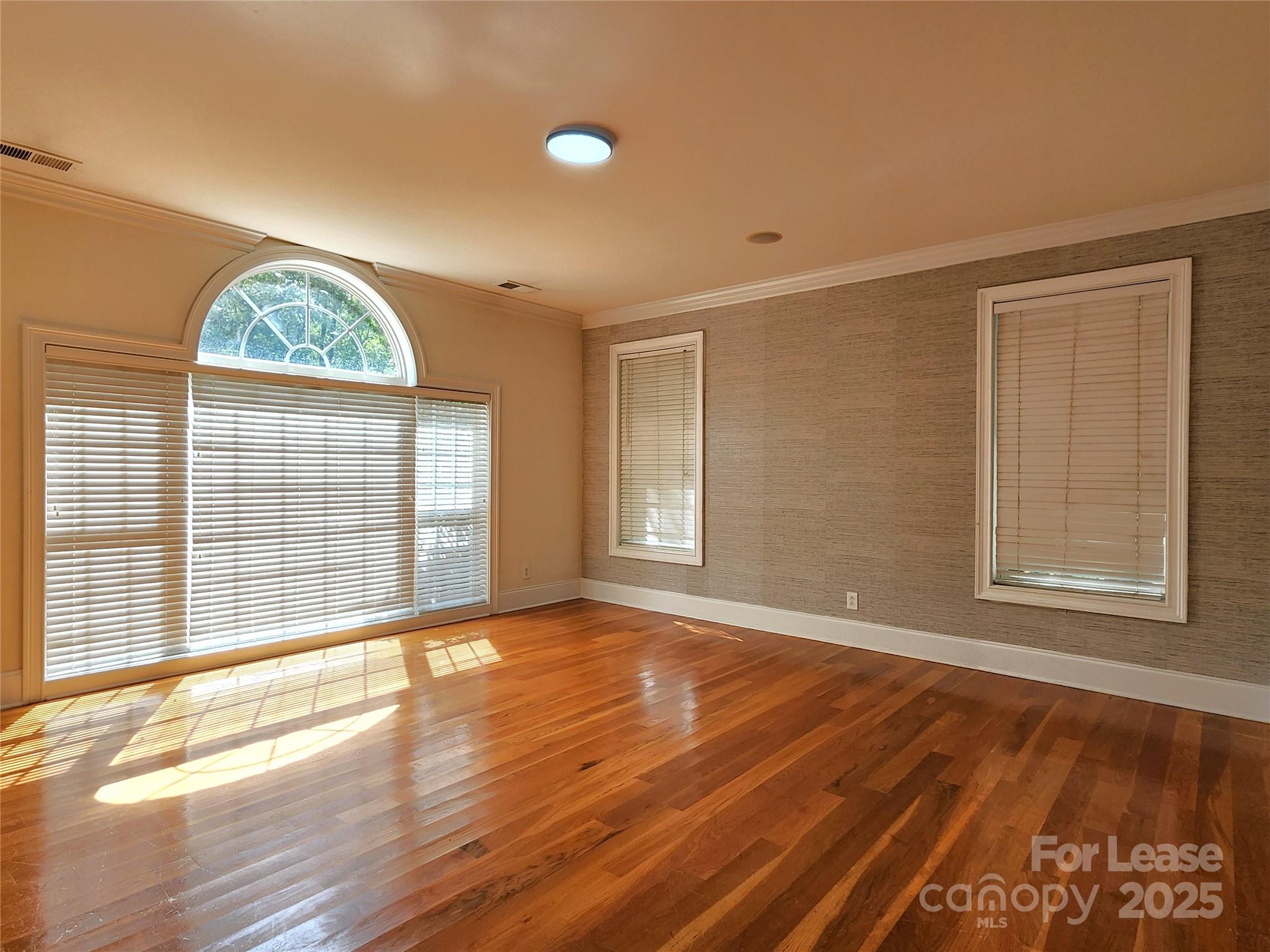 5524 Strabane Drive Matthews, NC 28104 - Photo 4 of 41 a view of an empty room with a window and wooden floor