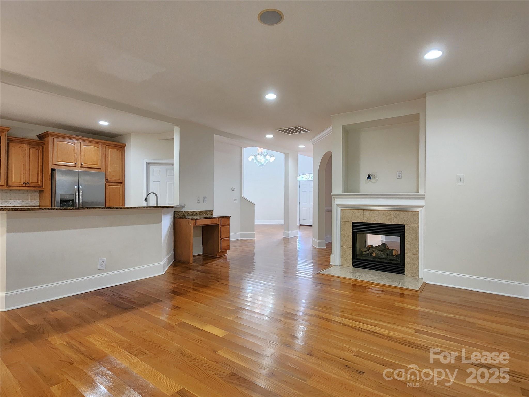 5524 Strabane Drive Matthews, NC 28104 - Photo 9 of 41 a view of a kitchen and an empty room with wooden floor