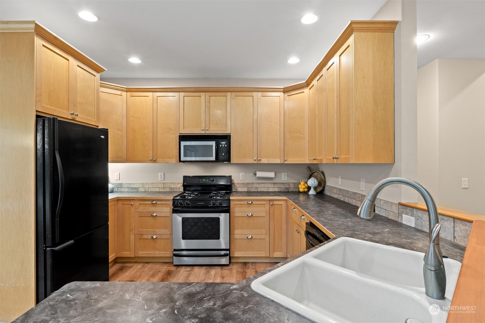 2068 Academy Road Bellingham, WA 98226 - Photo 17 of 40 a kitchen with stainless steel appliances a stove a sink a refrigerator and cabinets