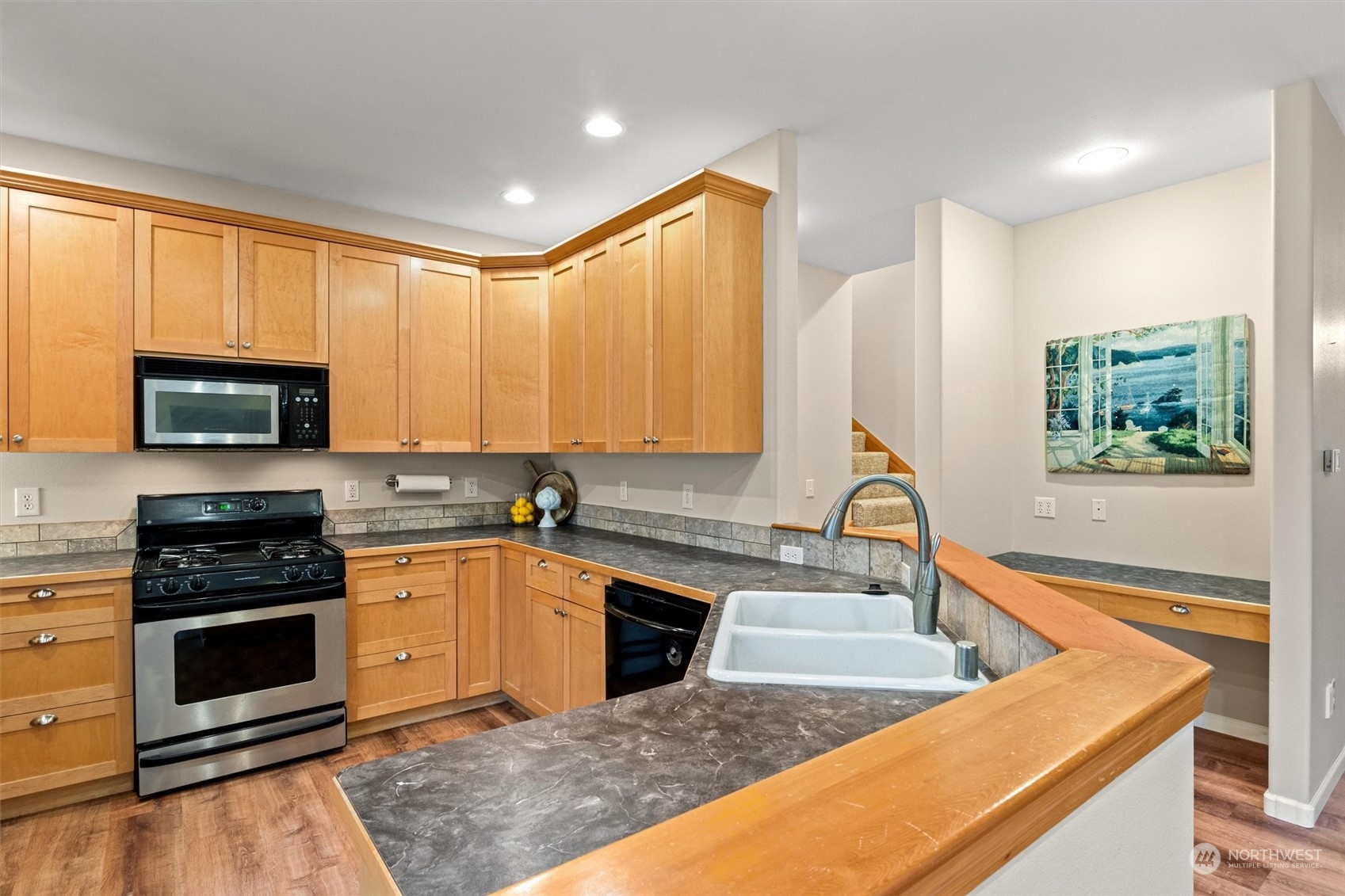 2068 Academy Road Bellingham, WA 98226 - Photo 19 of 40 a kitchen with stainless steel appliances granite countertop a sink stove and microwave