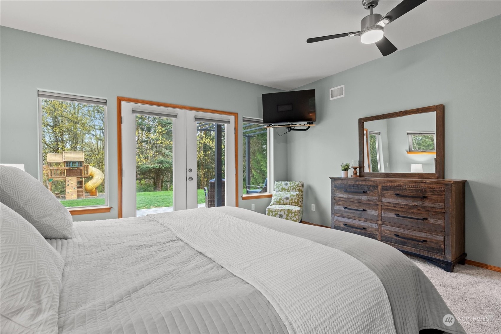 2068 Academy Road Bellingham, WA 98226 - Photo 24 of 40 a bedroom with a bed flat screen tv and a large window
