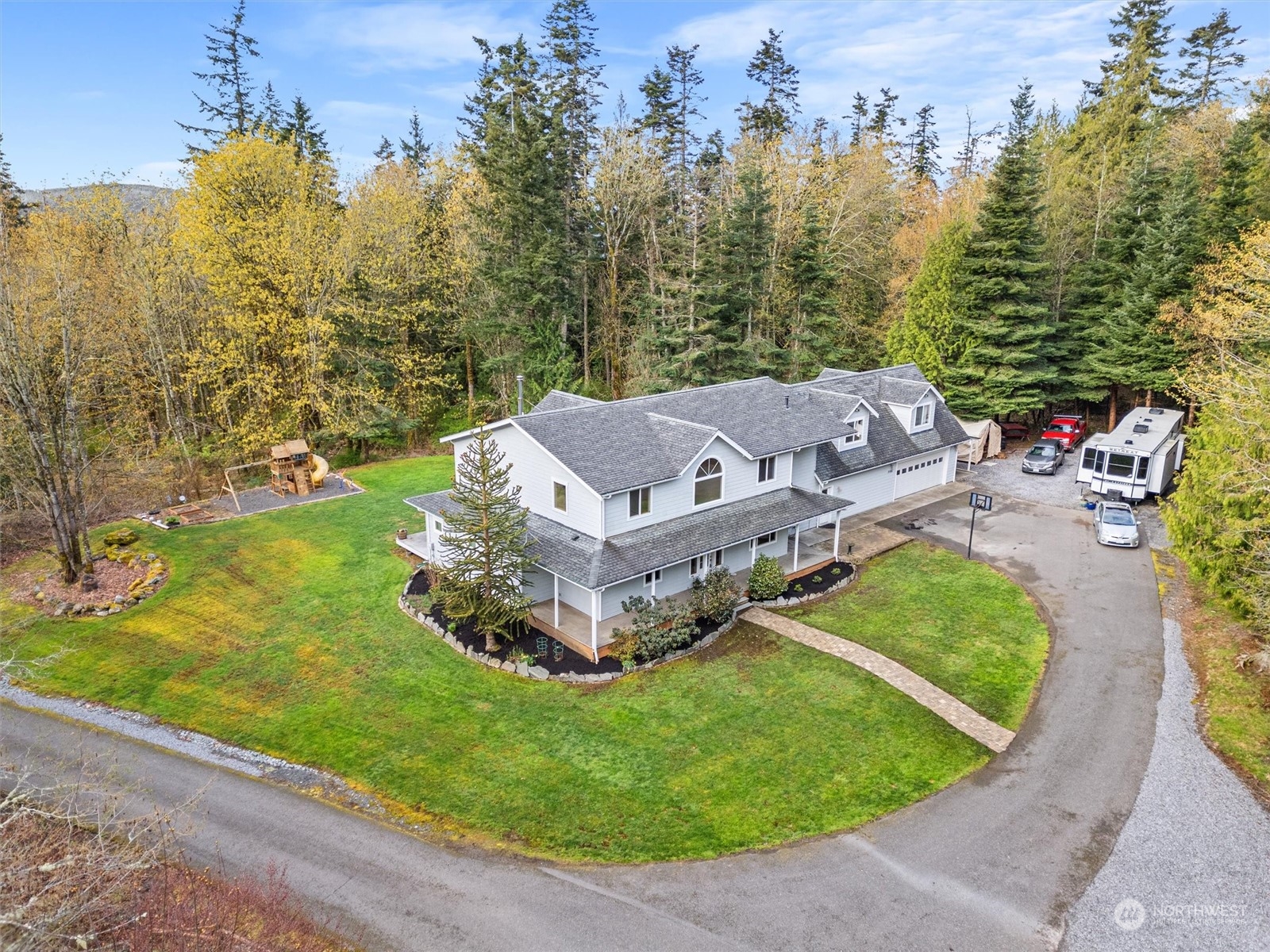 2068 Academy Road Bellingham, WA 98226 - Photo 4 of 40 an aerial view of a house with a garden and lake view