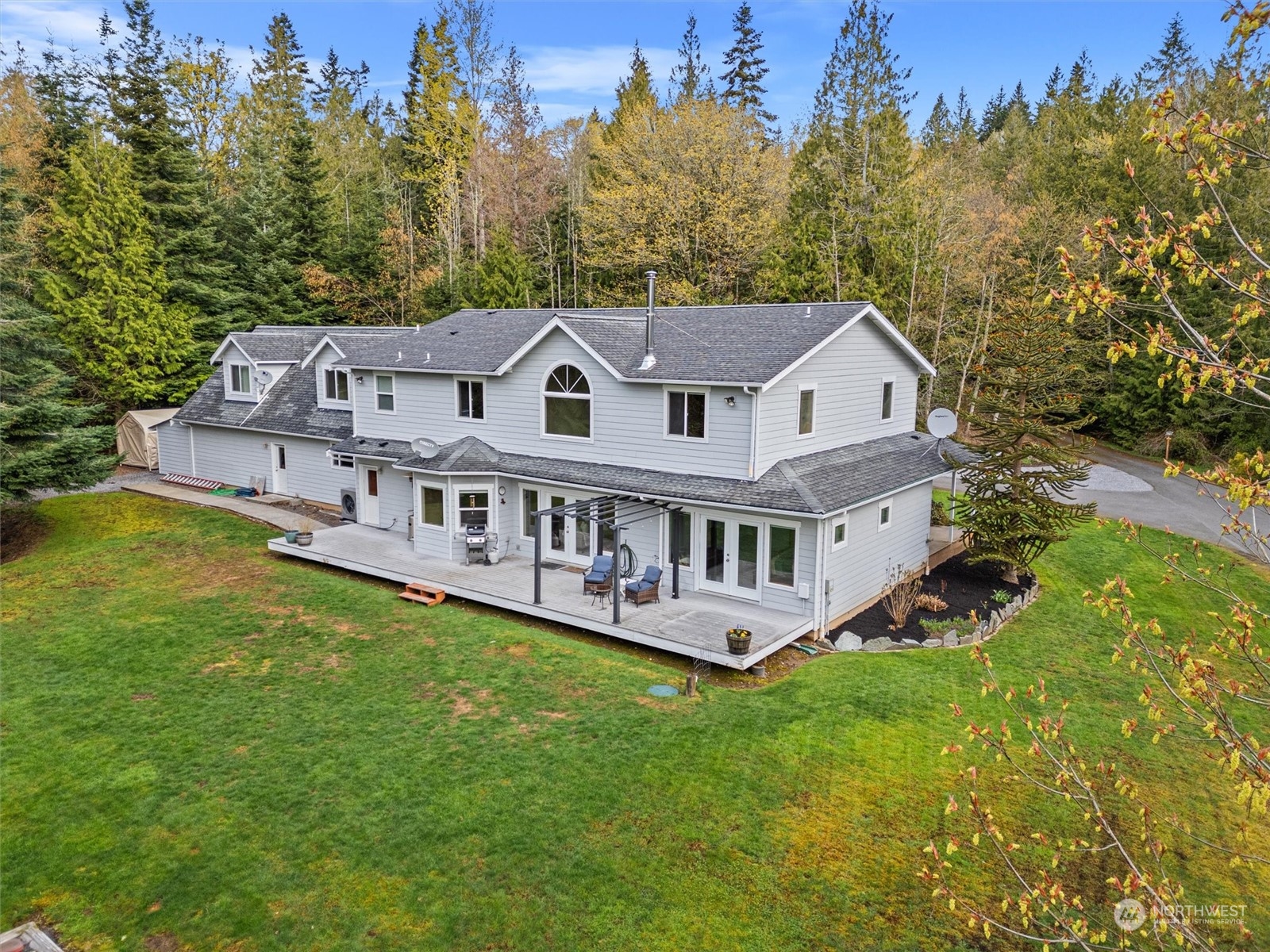 2068 Academy Road Bellingham, WA 98226 - Photo 6 of 40 a view of a house with a big yard and large trees