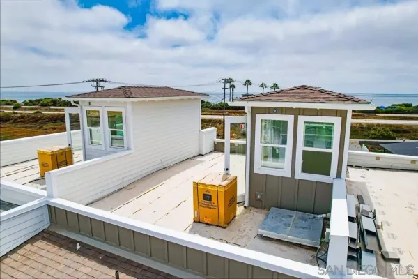 a view of a house with wooden floor and iron fence