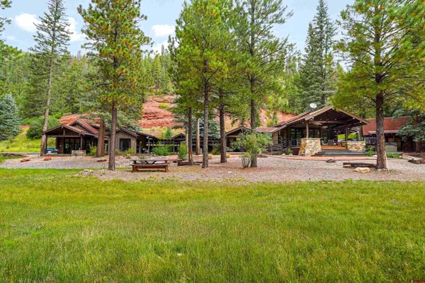a view of a house with backyard water fountain and sitting area