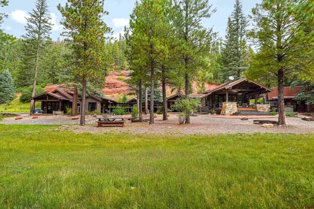a view of a house with backyard water fountain and sitting area