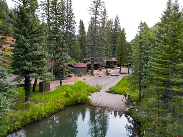a view of a house with a balcony and wooden fence