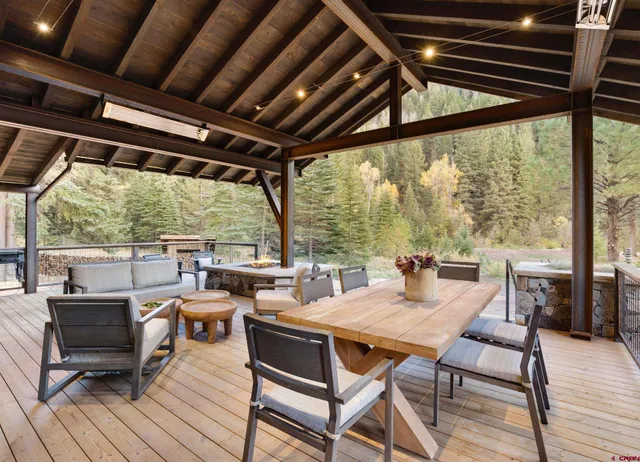 an aerial view of a house with a garden and lake view
