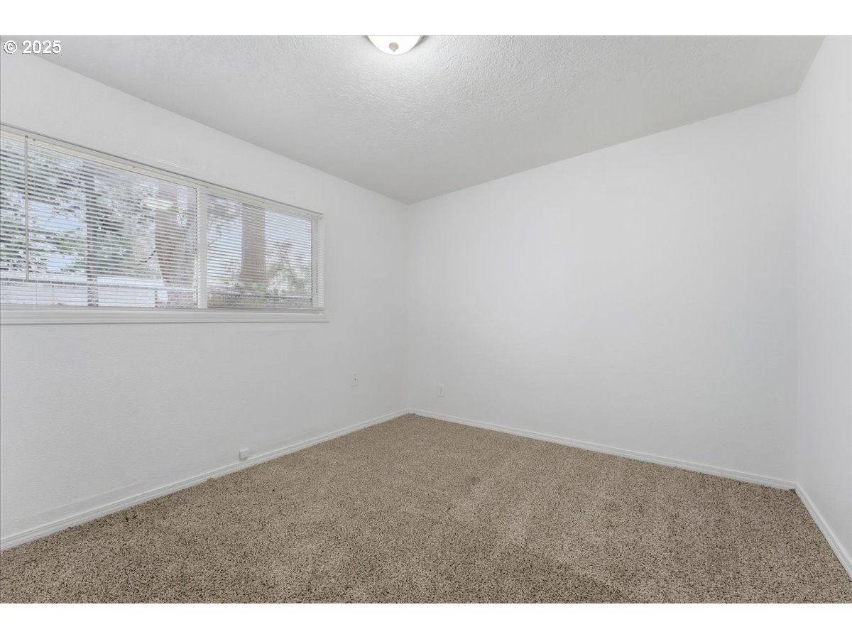 18427 Southeast Yamhill Street Gresham, OR 97233 - Photo 14 of 39 a view of an empty room with wooden floor and a window