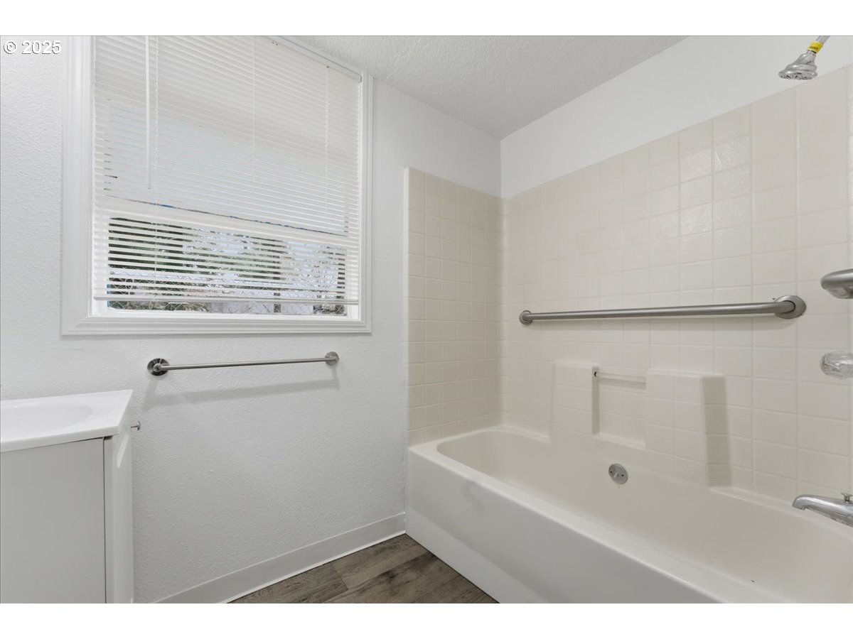 18427 Southeast Yamhill Street Gresham, OR 97233 - Photo 15 of 39 a bathroom with a bathtub sink and vanity