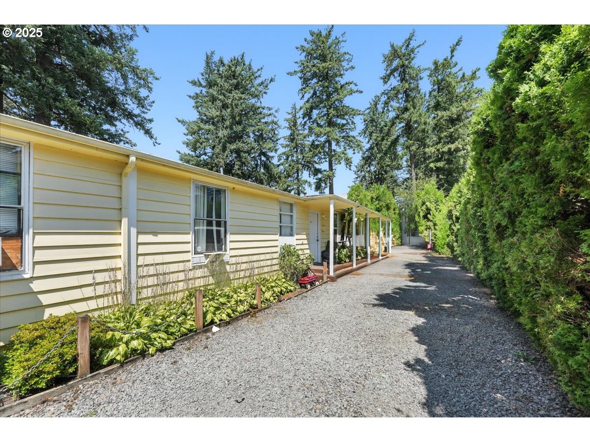 18427 Southeast Yamhill Street Gresham, OR 97233 - Photo 2 of 39 a view of a backyard with potted plants