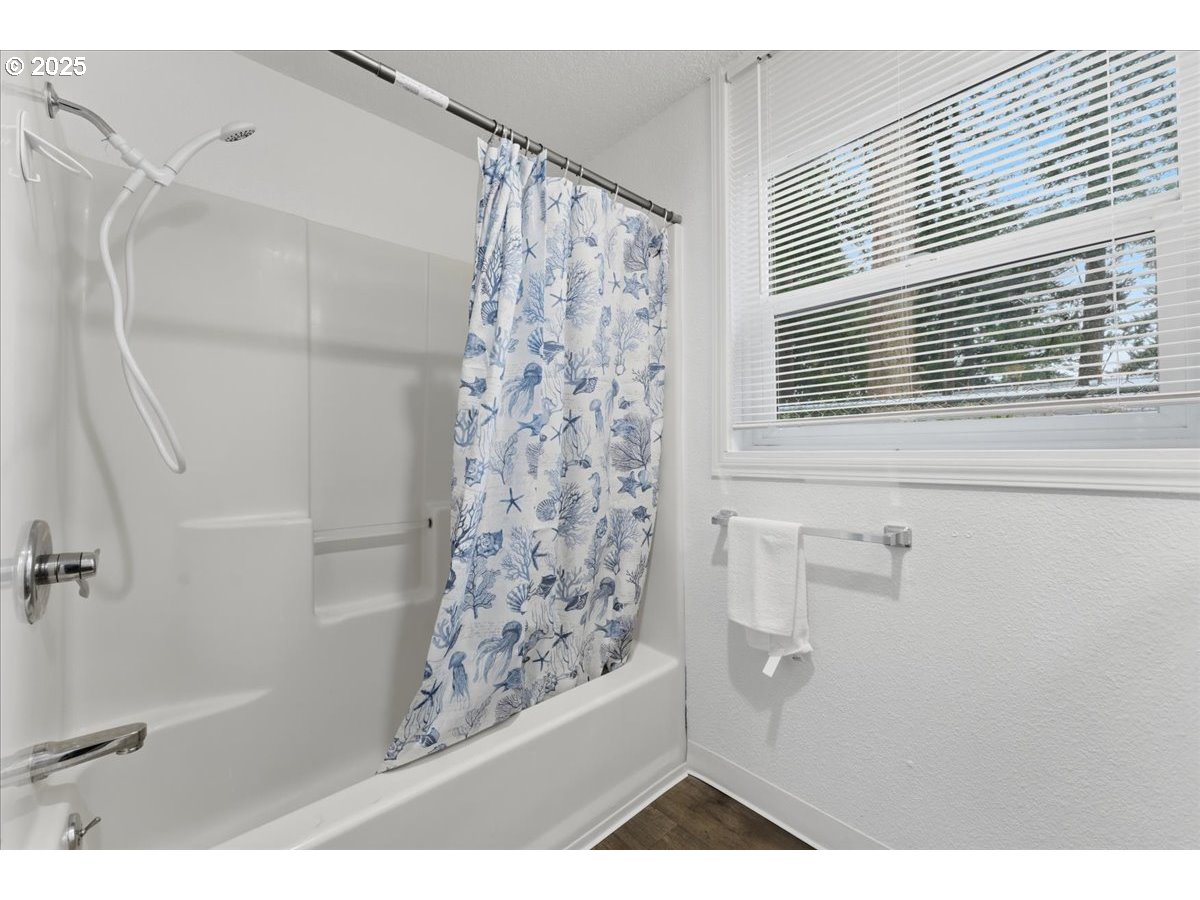 18427 Southeast Yamhill Street Gresham, OR 97233 - Photo 26 of 39 a view of a bathroom with a shower and a window