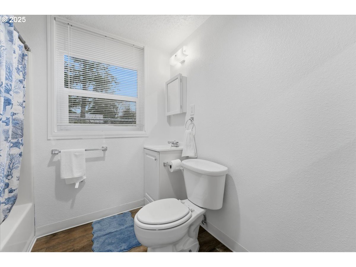 18427 Southeast Yamhill Street Gresham, OR 97233 - Photo 27 of 39 a white toilet sitting next to a bathroom sink