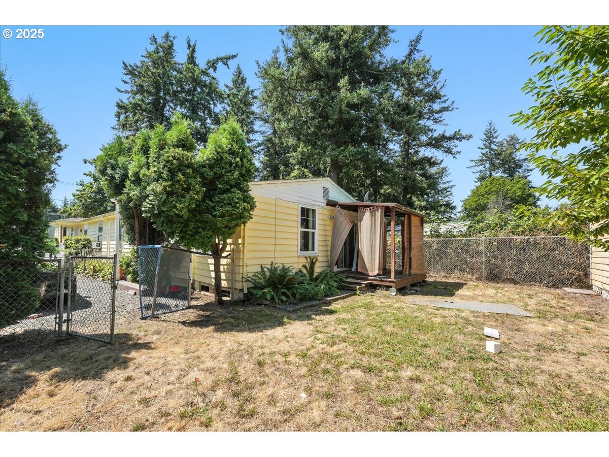 18427 Southeast Yamhill Street Gresham, OR 97233 - Photo 5 of 39 a backyard of a house with table and chairs