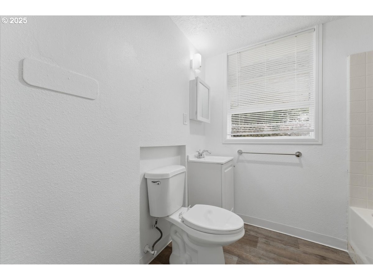 18427 Southeast Yamhill Street Gresham, OR 97233 - Photo 10 of 39 a bathroom with a toilet a sink a vanity and mirror