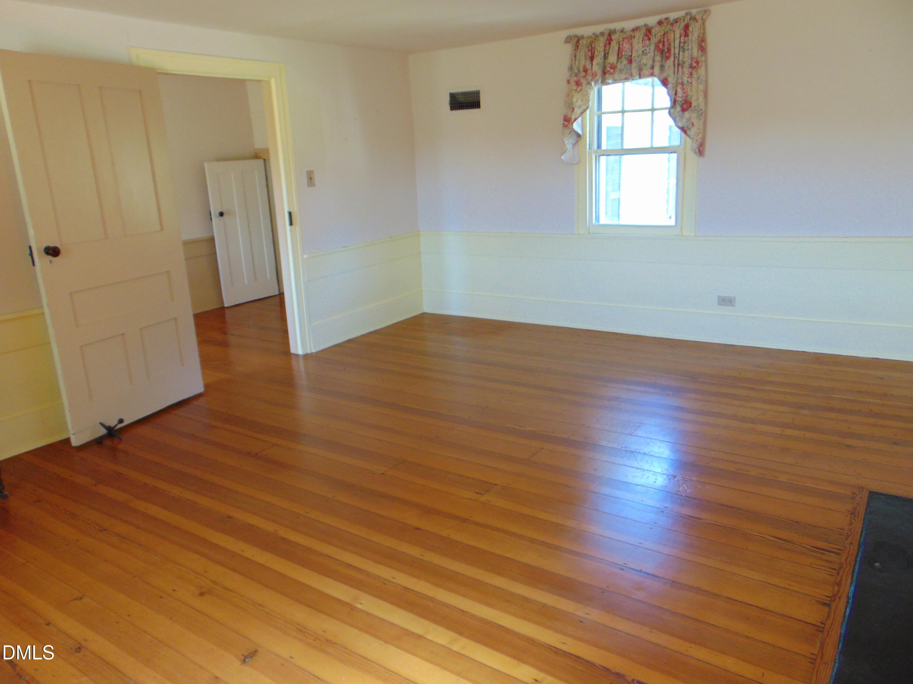 4067 Chewning Road Oxford, NC 27565 - Photo 69 of 82 an empty room with wooden floor and windows
