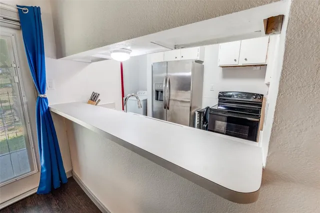a kitchen with stainless steel appliances a refrigerator and a stove