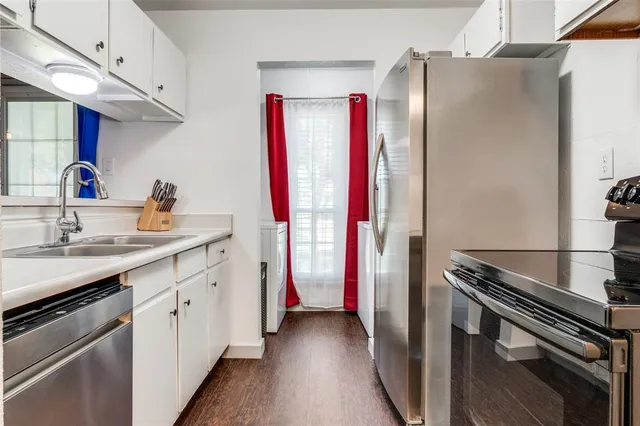 a kitchen with a sink and a refrigerator