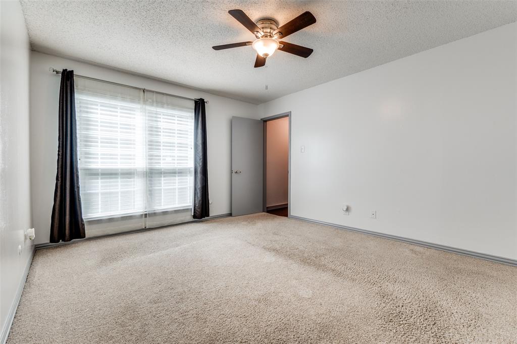 5981 Arapaho Road, Unit 1603 Dallas, TX 75248 - Photo 18 of 25 a view of a room with a ceiling fan and a window