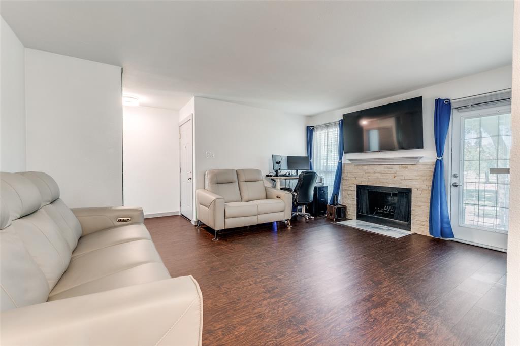 5981 Arapaho Road, Unit 1603 Dallas, TX 75248 - Photo 3 of 25 a living room with furniture and a fireplace