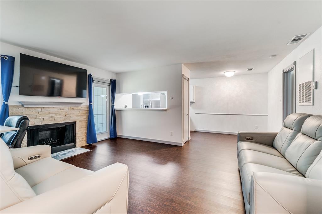 5981 Arapaho Road, Unit 1603 Dallas, TX 75248 - Photo 5 of 25 a living room with furniture and a fireplace