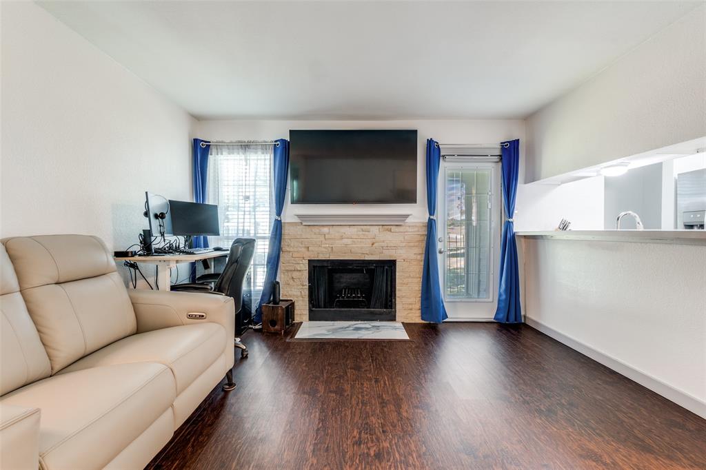 5981 Arapaho Road, Unit 1603 Dallas, TX 75248 - Photo 6 of 25 a living room with furniture a flat screen tv and a fireplace
