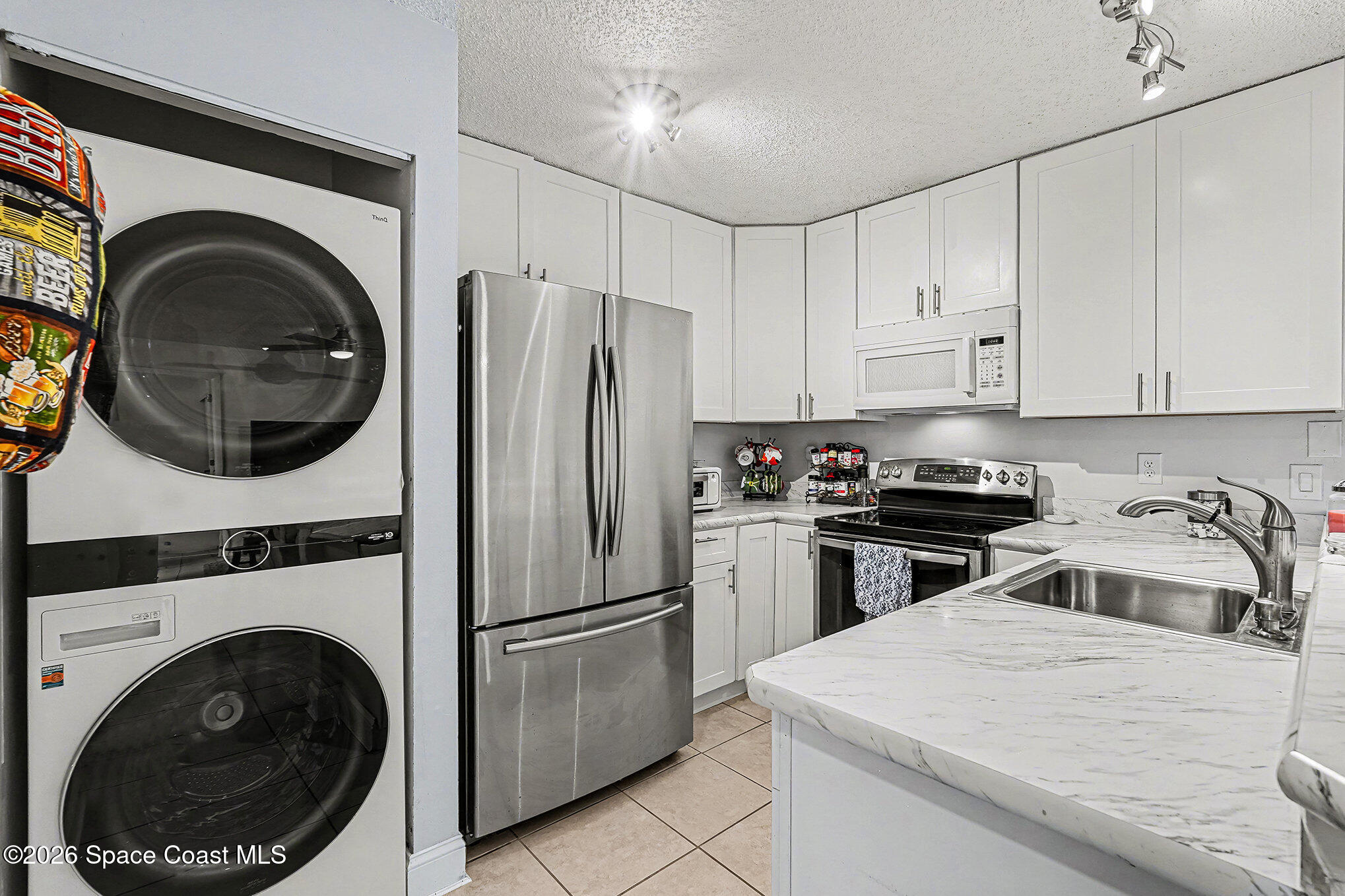 1491 Sheafe Avenue Northeast, Unit 104 Palm Bay, FL 32905 - Photo 5 of 19 a kitchen with a stove top oven and refrigerator