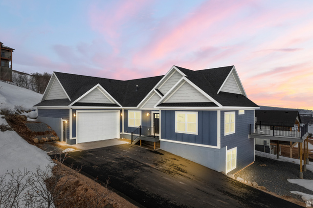 1343 North Trapper Loop Garden City, UT 84028 - Photo 1 of 56 View of front facade with board and batten siding, asphalt driveway, a shingled roof, and a garage