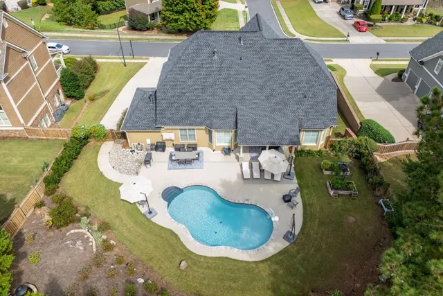 an aerial view of a house with swimming pool