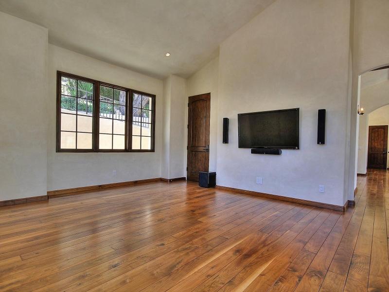 219 Conejo Road Santa Barbara, CA 93103 - Photo 12 of 24 a view of an empty room with wooden floor and windows