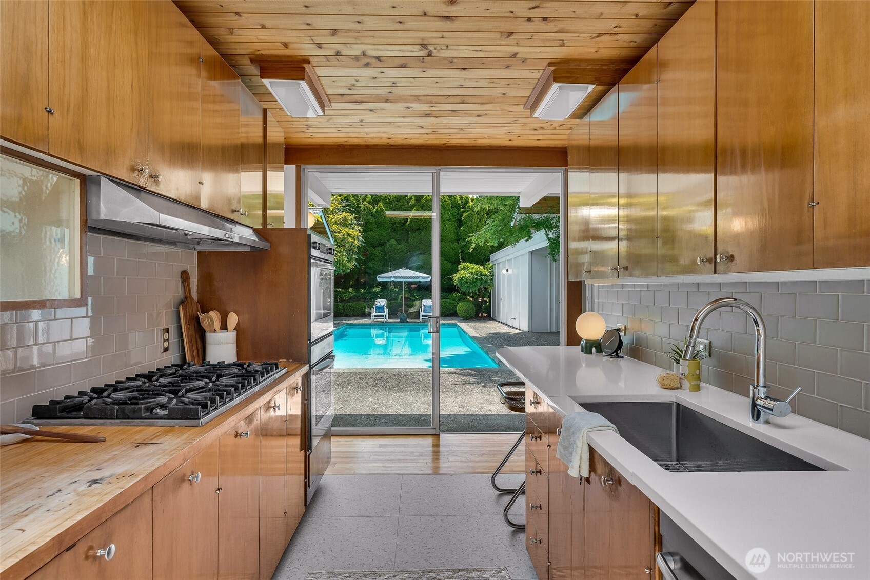 615 Bayside Road Bellingham, WA 98225 - Photo 14 of 31 a kitchen with a stove a sink and a wooden cabinets