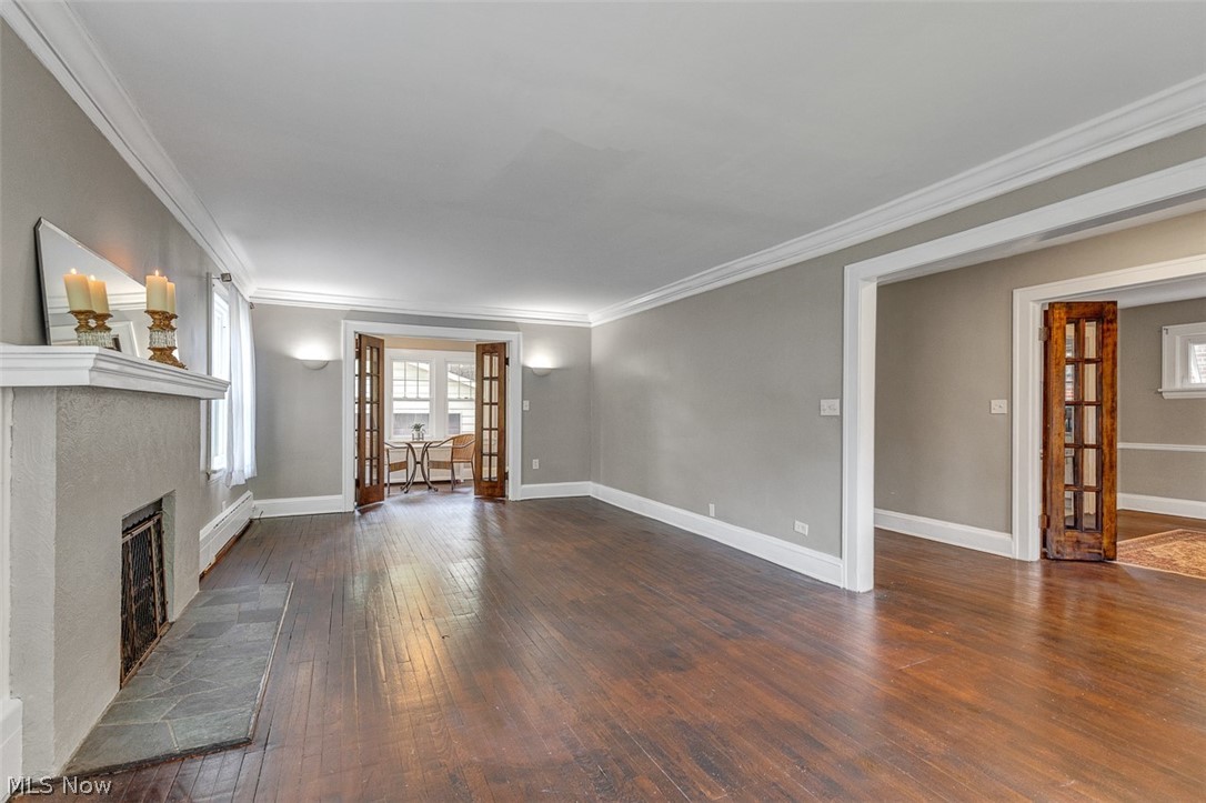 2972 Yorkshire Road Cleveland Heights, OH 44118 - Photo 8 of 44 Hardwood flooring extends throughout this expansive room, featuring a built-in fireplace with a stone hearth