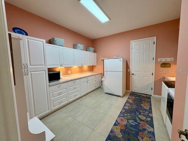 6261 Pinehurst Loop Winter Haven, FL 33884 - Photo 31 of 76 a kitchen with stainless steel appliances a refrigerator and a stove