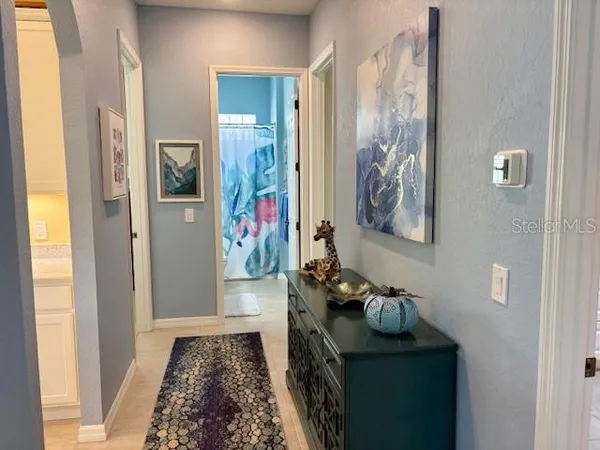 a spacious bathroom with a tub shower and mirror