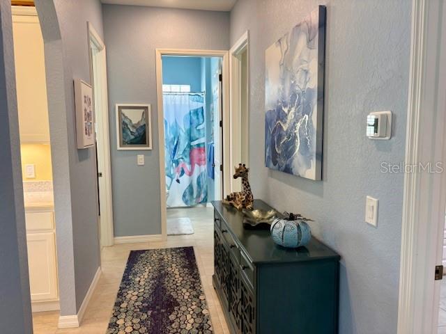 6261 Pinehurst Loop Winter Haven, FL 33884 - Photo 35 of 76 a hallway with painting on the wall and a window
