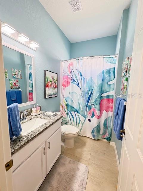 6261 Pinehurst Loop Winter Haven, FL 33884 - Photo 39 of 76 a bathroom with a granite countertop sink and a painting on the wall