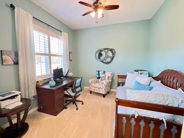 a view of a patio with a table chairs and a barbeque