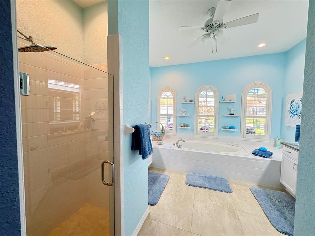 6261 Pinehurst Loop Winter Haven, FL 33884 - Photo 53 of 76 a spacious bathroom with a tub shower and mirror