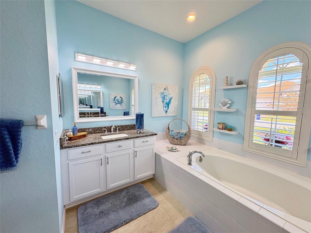 6261 Pinehurst Loop Winter Haven, FL 33884 - Photo 55 of 76 a large spacious bathroom with a large tub and large windows